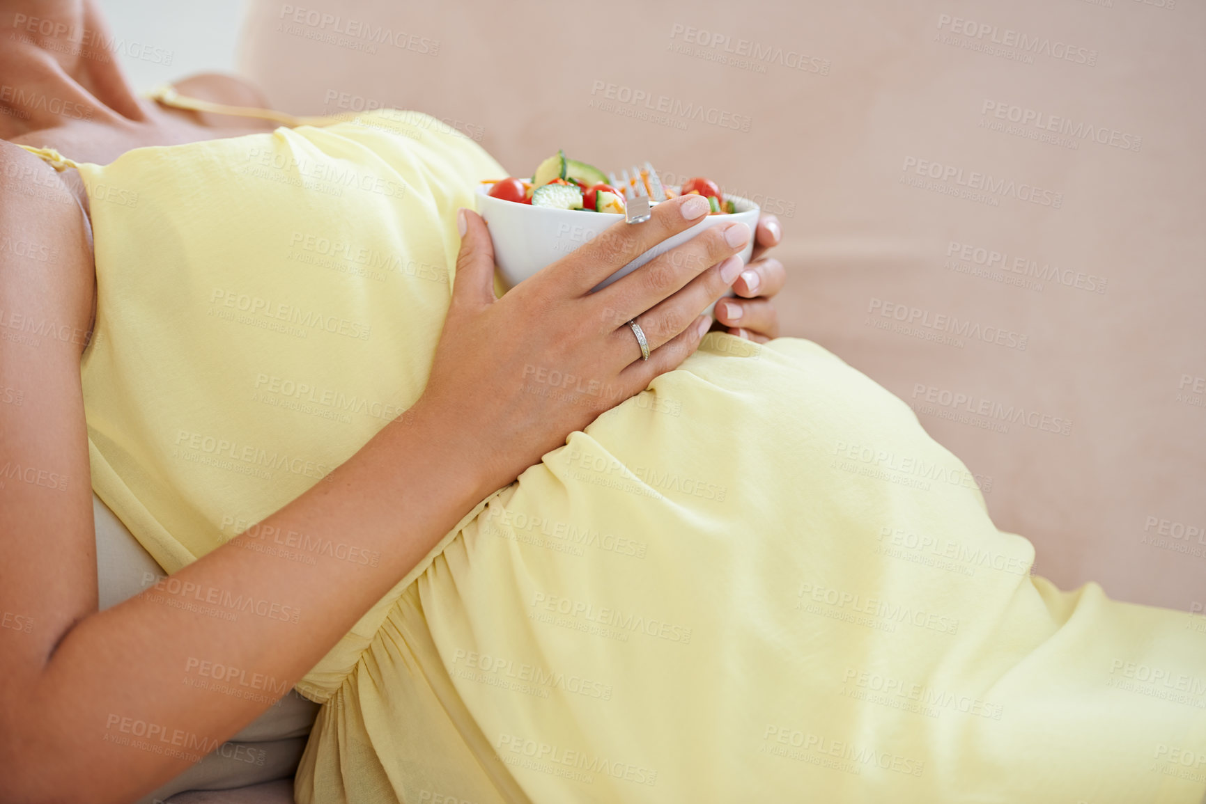 Buy stock photo Pregnant woman, eating salad and living room couch, alone and enjoying delicious pregnancy craving. Relaxed, vegetables and maternity wellness with healthy food meal and nutrition satisfaction
