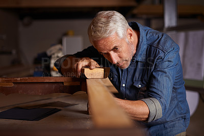 Buy stock photo Shot of a mature male carpenter working on a project in his workshop