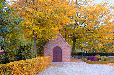 Buy stock photo Trees, church and autumn in outdoor for religion or spirituality, building for prayer with god. Nature, architecture and cross for faith or Jesus in countryside, christianity and worship in Denmark