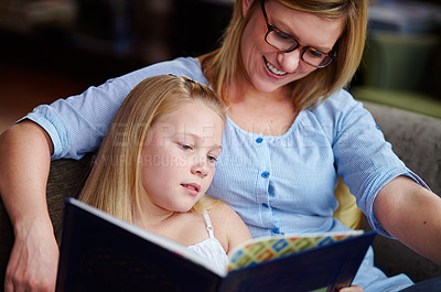 Buy stock photo Reading, storytelling and mother with child in library with smile, learning and relax with study knowledge. Books, happy mom and girl on bookstore sofa together with story, fantasy and education.