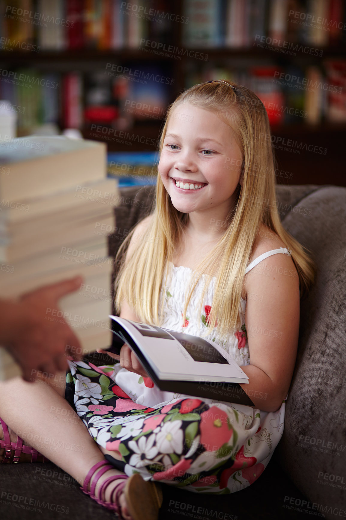 Buy stock photo Reading, stack of books and child in library with smile, learning and relax on sofa with study knowledge. Storytelling, happy girl in bookstore with story collection in fantasy and education on couch