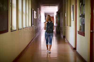 Buy stock photo Shot of a young girl in her school hallway