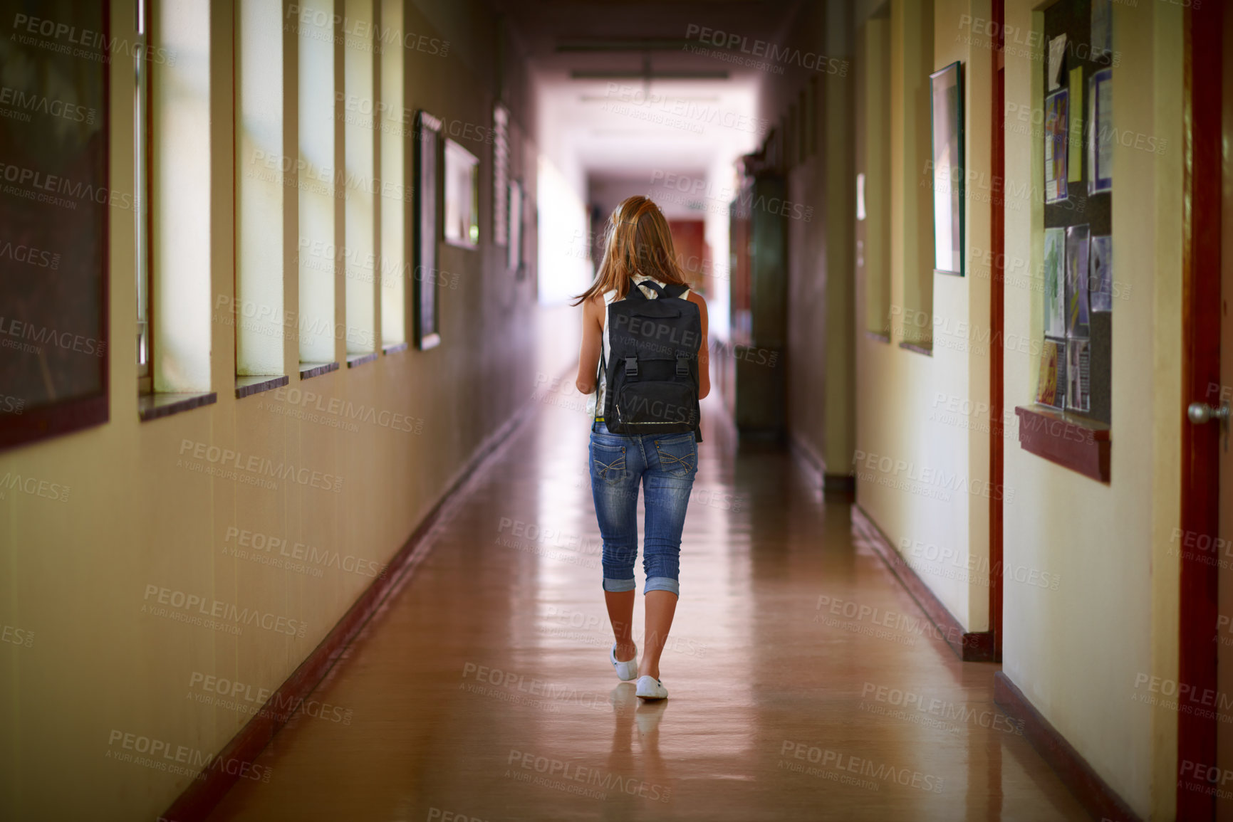 Buy stock photo Shot of a young girl in her school hallway