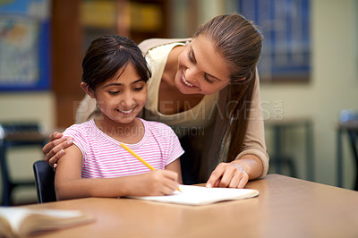 Buy stock photo School, education or study with a student and teacher in a classroom together for writing or child development. Learning, scholarship and teaching with a woman educator helping a girl child in class