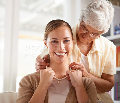Buy stock photo Necklace, jewellery and portrait of mother and woman for present, gift and surprise in living room. Family, pearls and happy daughter with senior mom on sofa for celebration, birthday and bonding