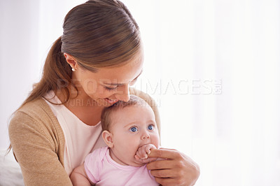 Buy stock photo Shot of a young mother bonding with her baby girl