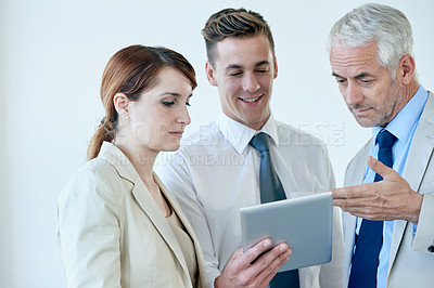 Buy stock photo Business people, tablet and discussion on project for partnership, communication and meeting in office. Coworkers, collaboration and tech for research on internet, planning and teamwork in workplace