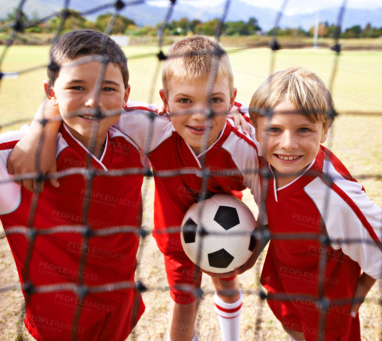 Buy stock photo Kids, soccer team and portrait with smile, goal net and boys with teamwork, support or solidarity. Energy, sports and friendship, together and happy for win, ready for game and physical activity