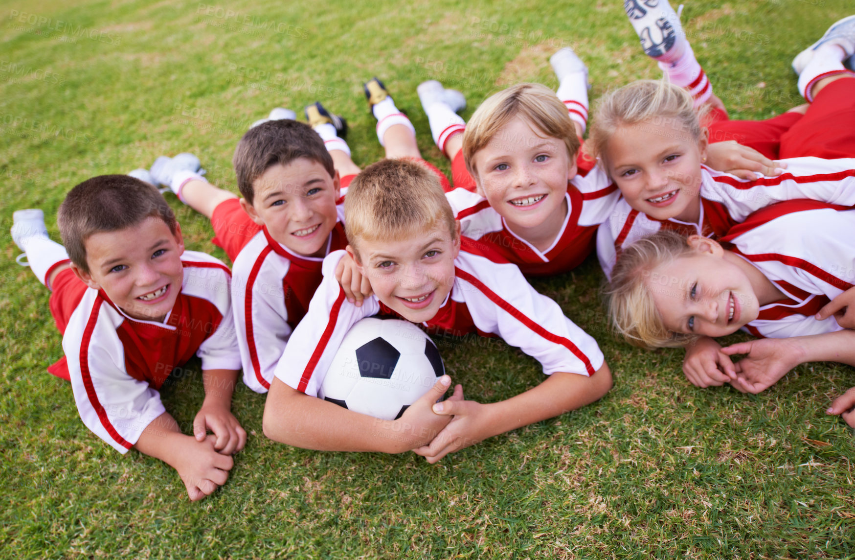 Buy stock photo Children, soccer team and portrait with ball, boys and girls on field, happy and united. Energy, sports and friendship, together and happpiness for win, teamwork for game and physical activity 
