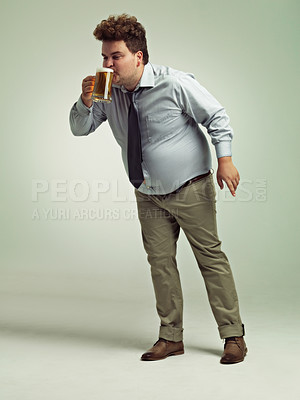 Buy stock photo Man, obesity and drinking with beer for alcohol, belly or party on a studio background. Male person or plus size model with keg, glass or mug for beverage, wine or unhealthy drink on mockup space