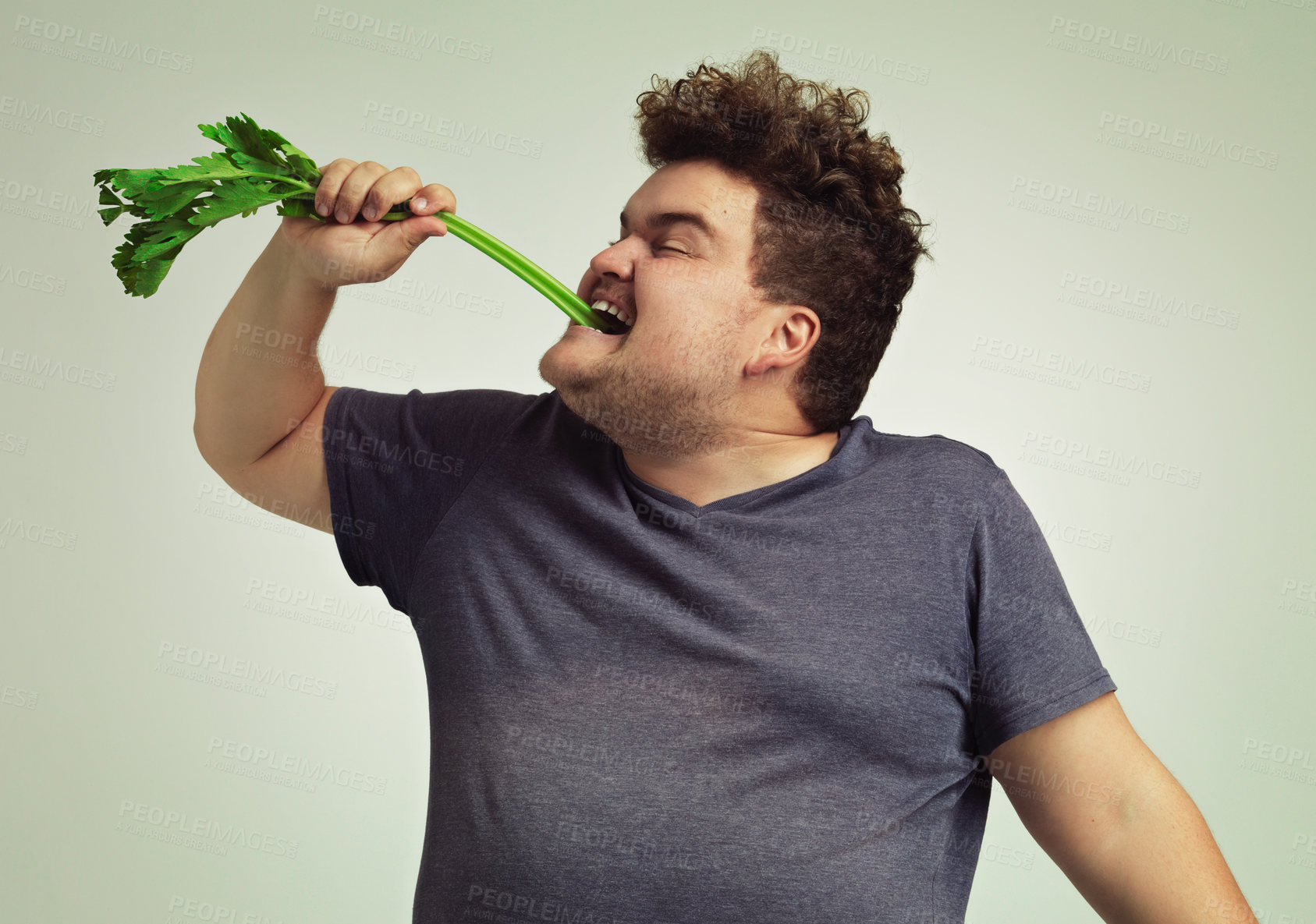 Buy stock photo Diet, plus size and man eating vegetable for health benefit, nutrition and wellness in studio in white background. Weight loss, celery stick and male person for healthy food, wellbeing and detox