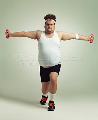 Buy stock photo Shot of an overweight man doing lunges while holding up dumbbells