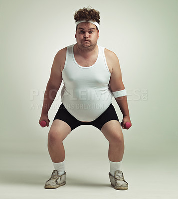 Buy stock photo Portrait of an overweight man squatting and lifting dumbbells