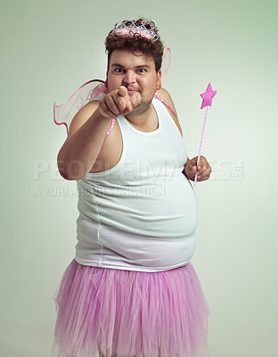 Buy stock photo An overweight man in a pink fairy costume pointing at the camera