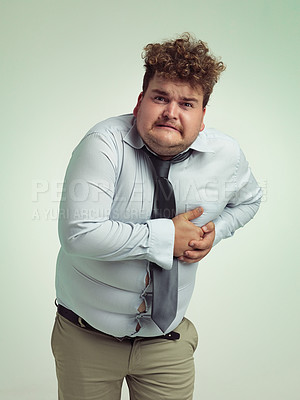 Buy stock photo Man, portrait and plus size with heart attack, cardiac arrest or ache on a studio background. Frustrated male person or big model with body pain or cholesterol in unhealthy weight on mockup space