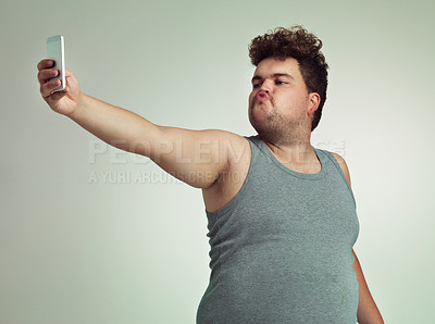 Buy stock photo Selfie, phone and plus size man in studio posing with casual, trendy and cool outfit with stomach. Cellphone, pout and overweight male person with photography picture isolated by gray background.