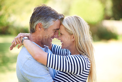 Buy stock photo Cropped shot of an affectionate mature couple in the park
