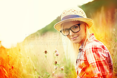Buy stock photo Field, countryside and portrait of woman with flowers for freedom, wellness and fresh air outdoors. Nature, summer and lens flare for female person in wild meadow for relaxing, calm and peace morning