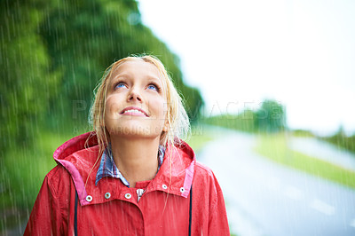 Buy stock photo Woman, smile and raincoat in outdoor rainfall, wet and cold from weather, winter and nature. Happy female person, fashion and red jacket is cool, rain and looking up to sky by water, face and holiday