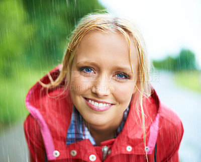 Buy stock photo Woman, smile and raincoat in nature rainfall, wet and cold from rain, weather and outdoors. Happy person, fashion and red coat in portrait, storm and protection from water, vacation and travel