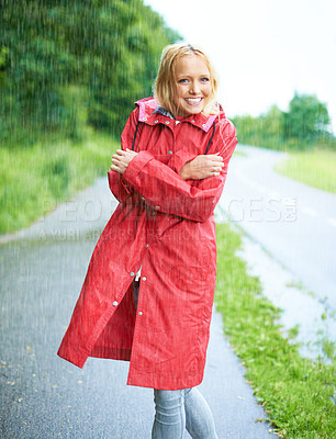Buy stock photo Raining, portrait and young woman with coat in nature, road or street for winter in countryside. Smile, positive attitude and female person from Canada in drizzle or storm weather in outdoor forest.
