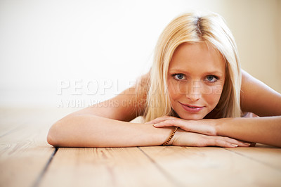 Buy stock photo Portrait, relax and smile of woman on floor in home in living room alone. Face, natural beauty and confident blonde girl in house, lounge or apartment with comfort, attractive or happy in Switzerland