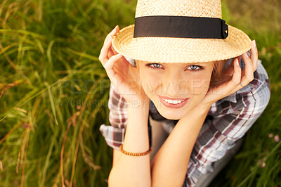 Buy stock photo Portrait, hat and young woman in nature with a straw accessory sitting in an outdoor garden for fresh air. Happy, fashion and female person from Australia in forest, woods or field with casual style.