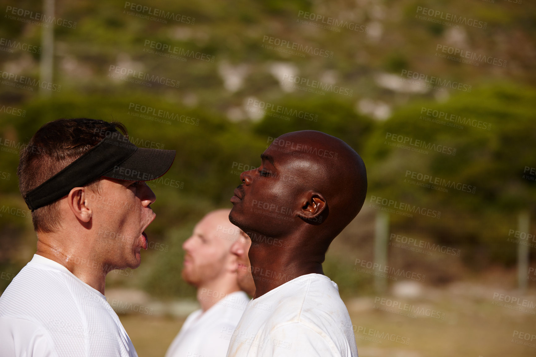 Buy stock photo Shot of a man being shouted at by the training officer at a military bootcamp