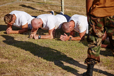 Buy stock photo Shot of a group of men doing push-ups at a military bootcamp