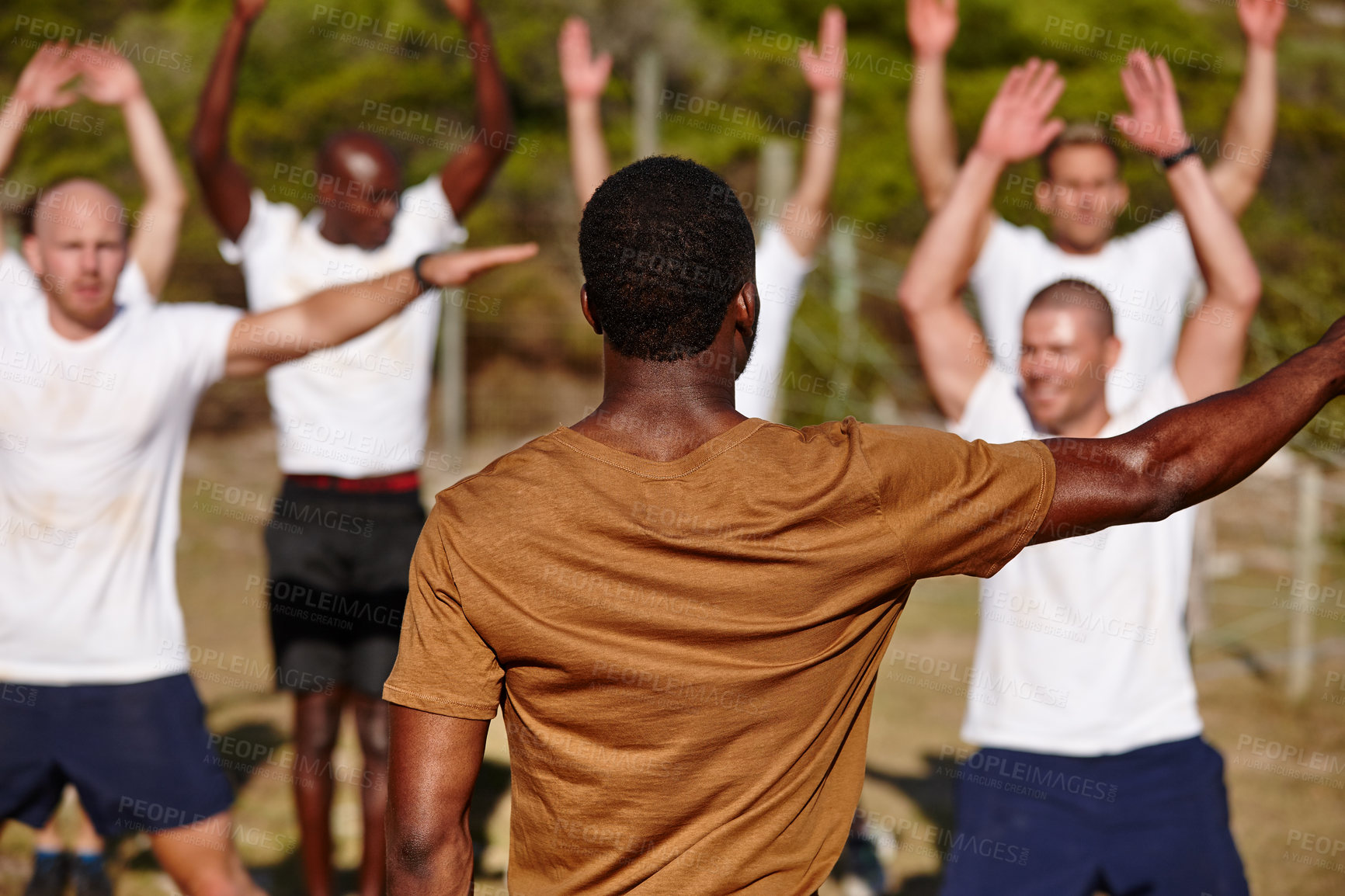 Buy stock photo Shot of a group of men doing exercises at a military bootcamp