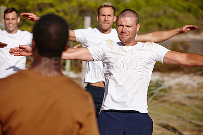 Buy stock photo Shot of a group of men doing exercises at a military bootcamp