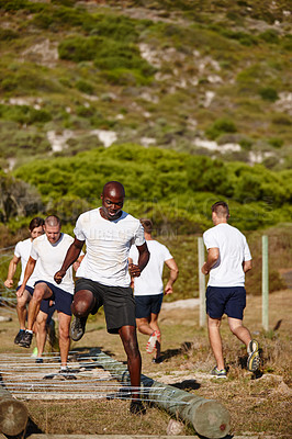 Buy stock photo Shot of a group of men doing drills at a military bootcamp