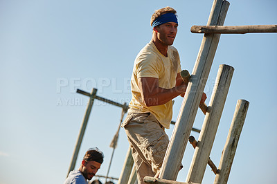 Buy stock photo Shot of men going through an obstacle course at bootcamp