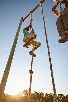 Buy stock photo Shot of two men climbing up ropes at a military bootcamp