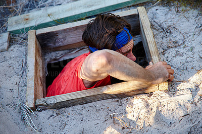 Buy stock photo Shot of a young man going through an obstacle course at bootcamp