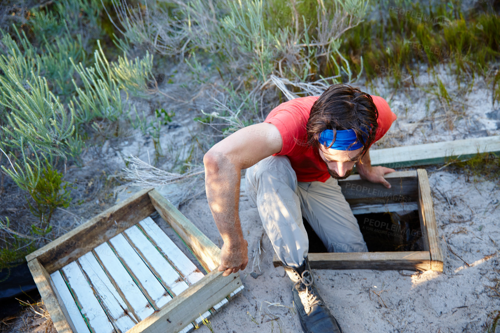 Buy stock photo Shot of a young man going through an obstacle course at bootcamp