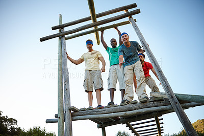 Buy stock photo Shot of a group of men going through an obstacle course at bootcamp