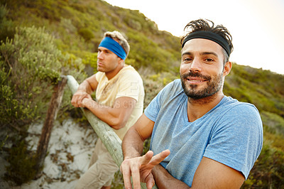 Buy stock photo Shot of two young men taking a break during bootcamp