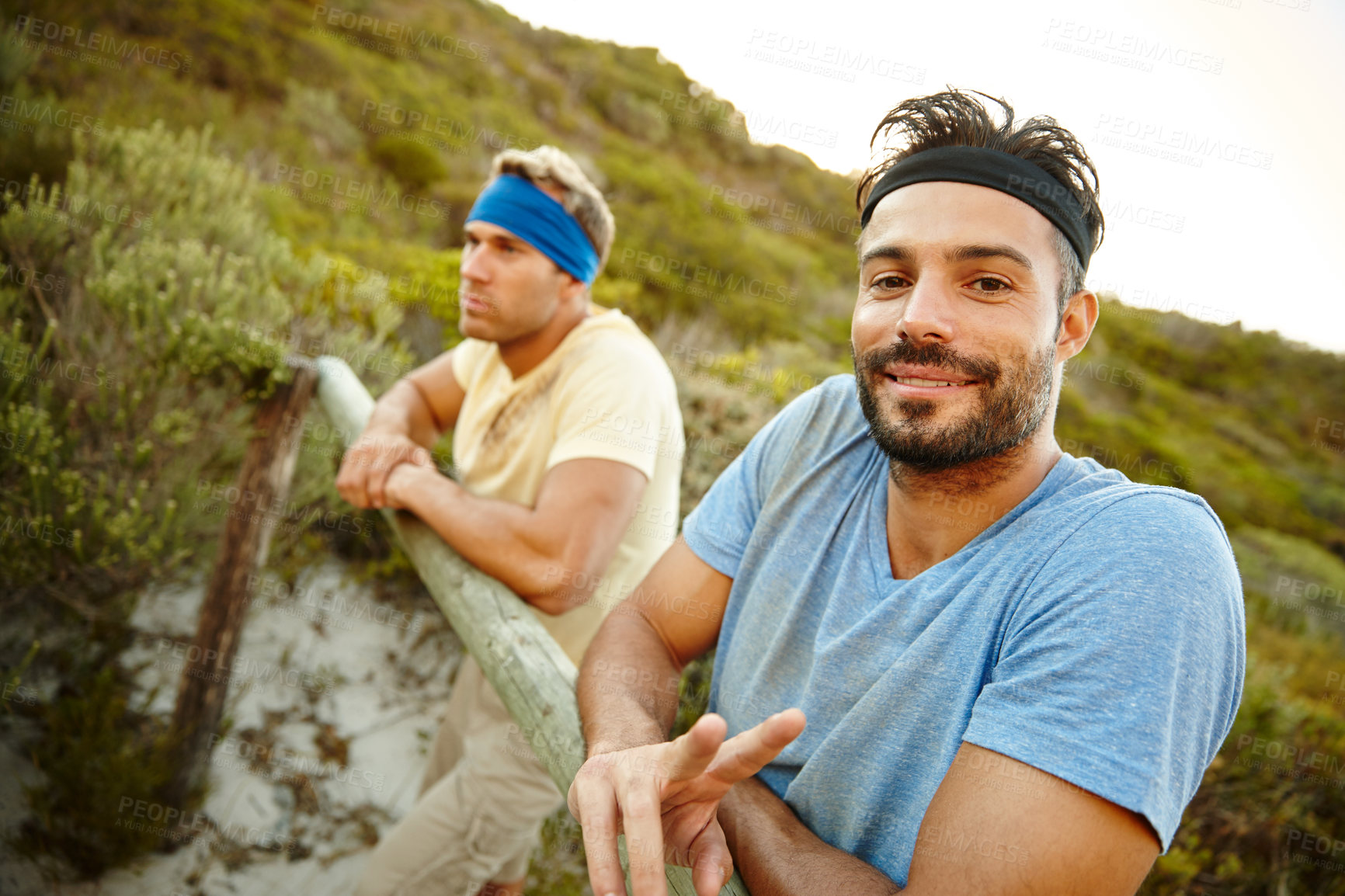 Buy stock photo Shot of two young men taking a break during bootcamp