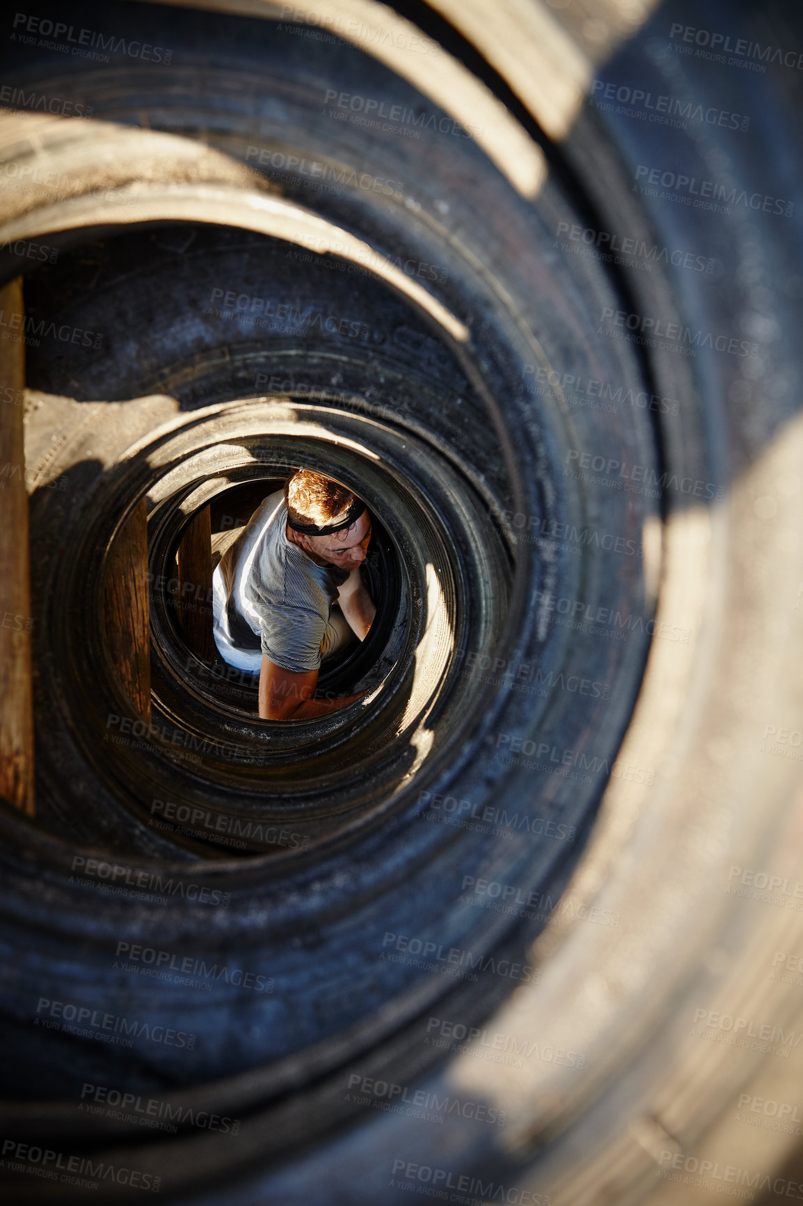 Buy stock photo Shot of a young man going through an obstacle at a military bootcamp