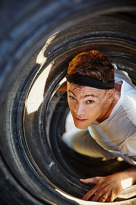 Buy stock photo Shot of a young man going through an obstacle at a military bootcamp