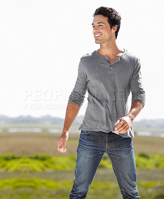 Buy stock photo A handsome young man looking away and smiling