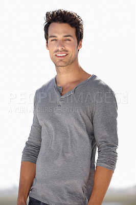 Buy stock photo Portrait of a handsome young man smiling while standing outside