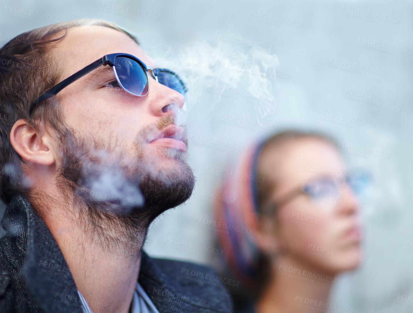 Buy stock photo Face, man and woman smoking outdoor with sunglasses for experience, relax and cigarette enjoyment. People, hipster and smoke for trend, exhale or tobacco satisfaction with shades and confidence
