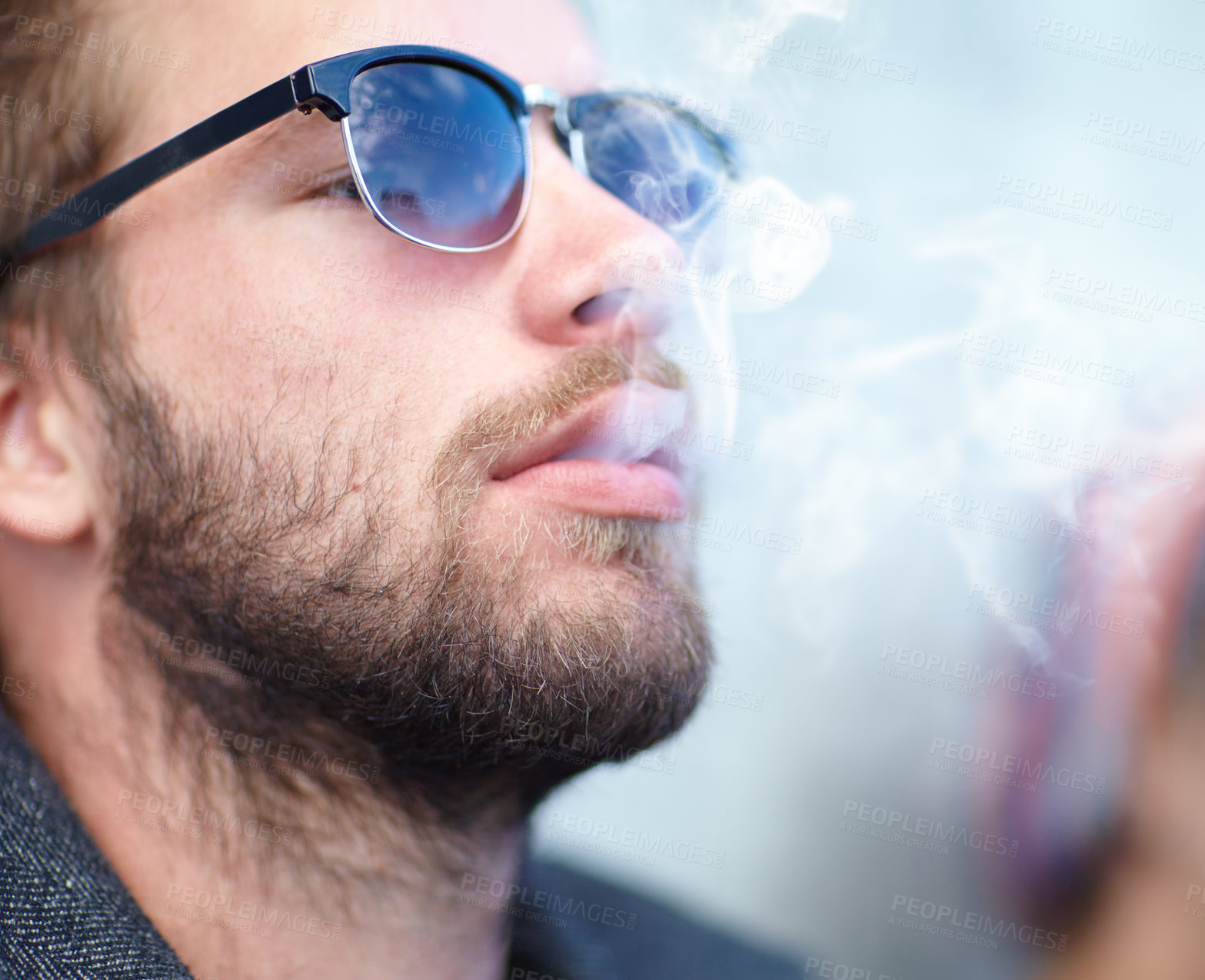 Buy stock photo Face, man and smoking with sunglasses for experience, fun and cigarette enjoyment outdoor. Person, hipster and guy with smoke for exhale, serious and smoker with tobacco satisfaction and shades