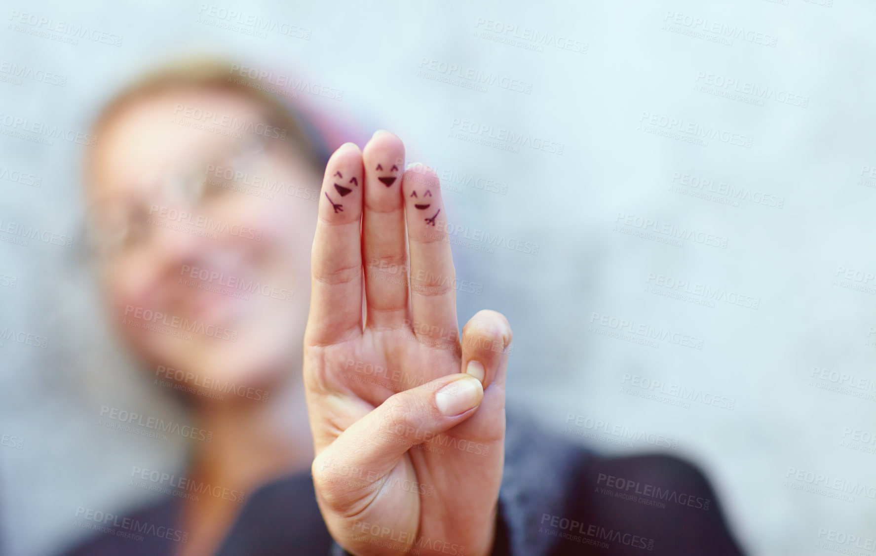 Buy stock photo Cropped shot of fingers with smileys drawn on them