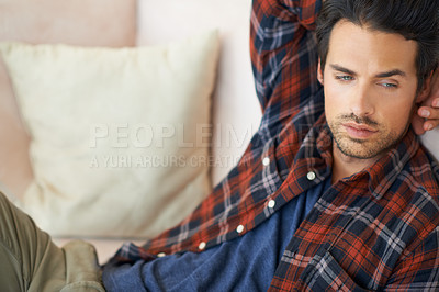 Buy stock photo Relax, thinking and man on sofa in home for afternoon nap, resting and calm in living room. Tired, thoughtful and person on couch lying for dreaming, comfortable and peace in apartment for wellness