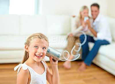 Buy stock photo Portrait, tin can and girl with parents, house and happiness with game, playing and bonding together. Face, kid and child with mother, father on a sofa or cheerful with fun, home or talking in lounge