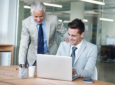 Buy stock photo Senior businessman, employee and laptop for problem solving, leadership and mentor on tech. Businesspeople, consulting and advice or feedback on report, proposal and discussion or teaching in office