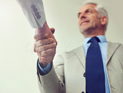 Buy stock photo Handshake, senior businessman and agreement in partnership, teamwork and thank you for recruitment. Male person, low angle and deal for merger in workplace, collaboration and support in cooperation